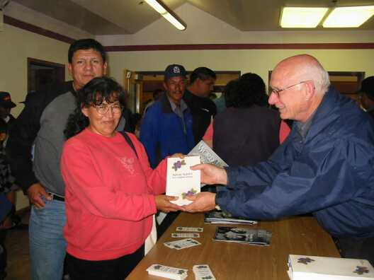 Madelaine receives Bible from Hart Wiens